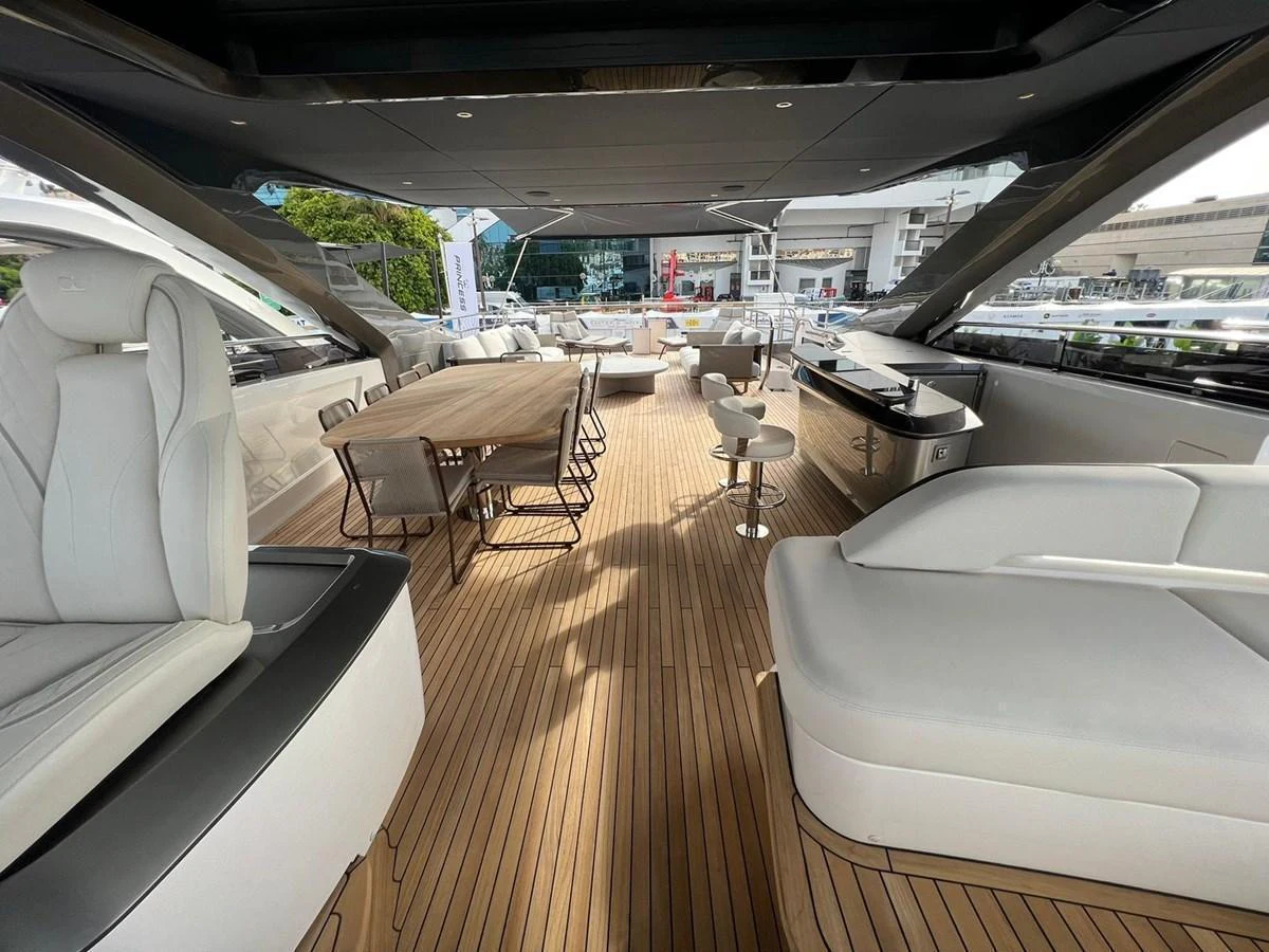 The spacious flybridge offers ample seating and a stylish dining area under a sleek hardtop. aboard LEILANI Yacht for Sale