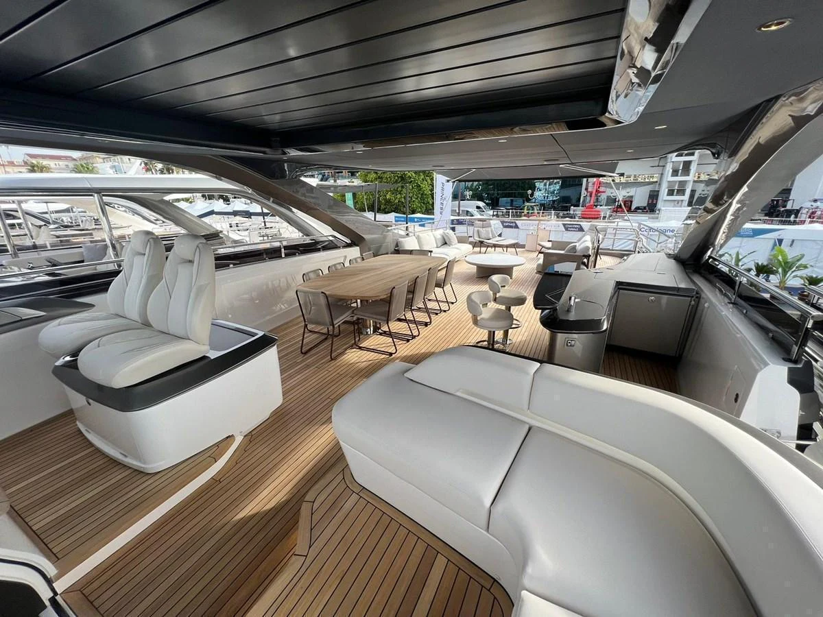 The aft deck features a spacious seating area with luxurious furnishings and a dining table, perfect for outdoor relaxation and entertaining. aboard LEILANI Yacht for Sale