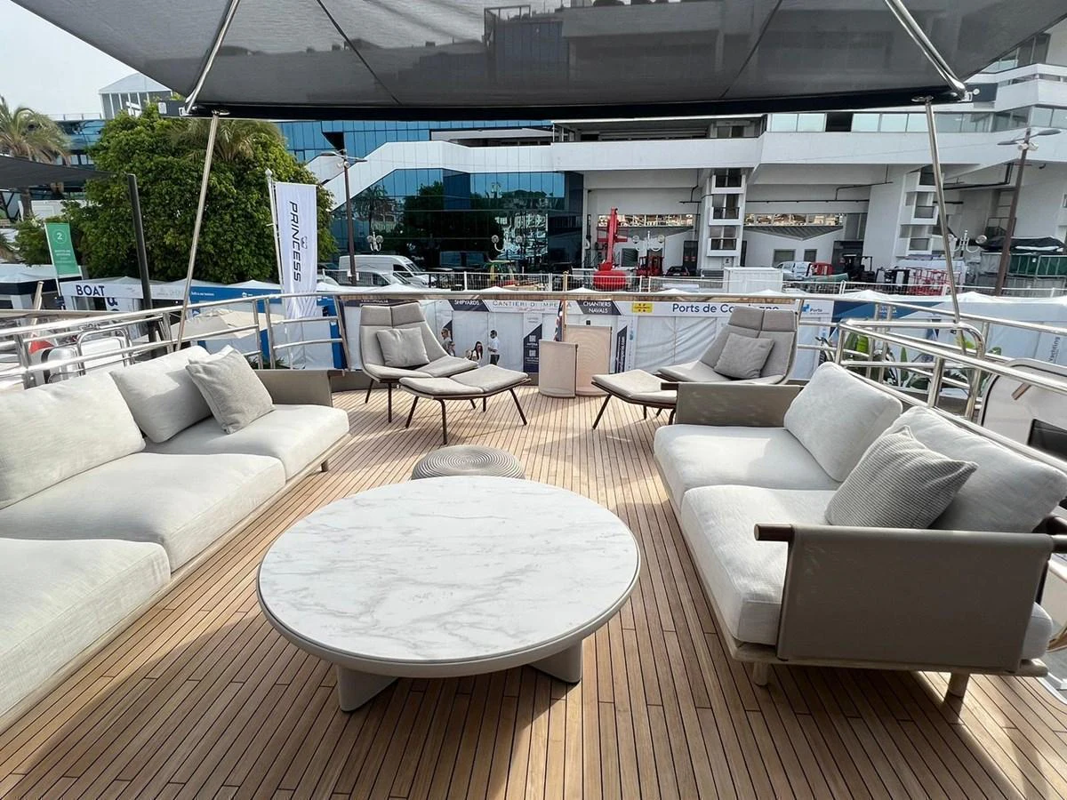 The sundeck features comfortable seating and a stylish round table, perfect for relaxation and socializing. aboard LEILANI Yacht for Sale
