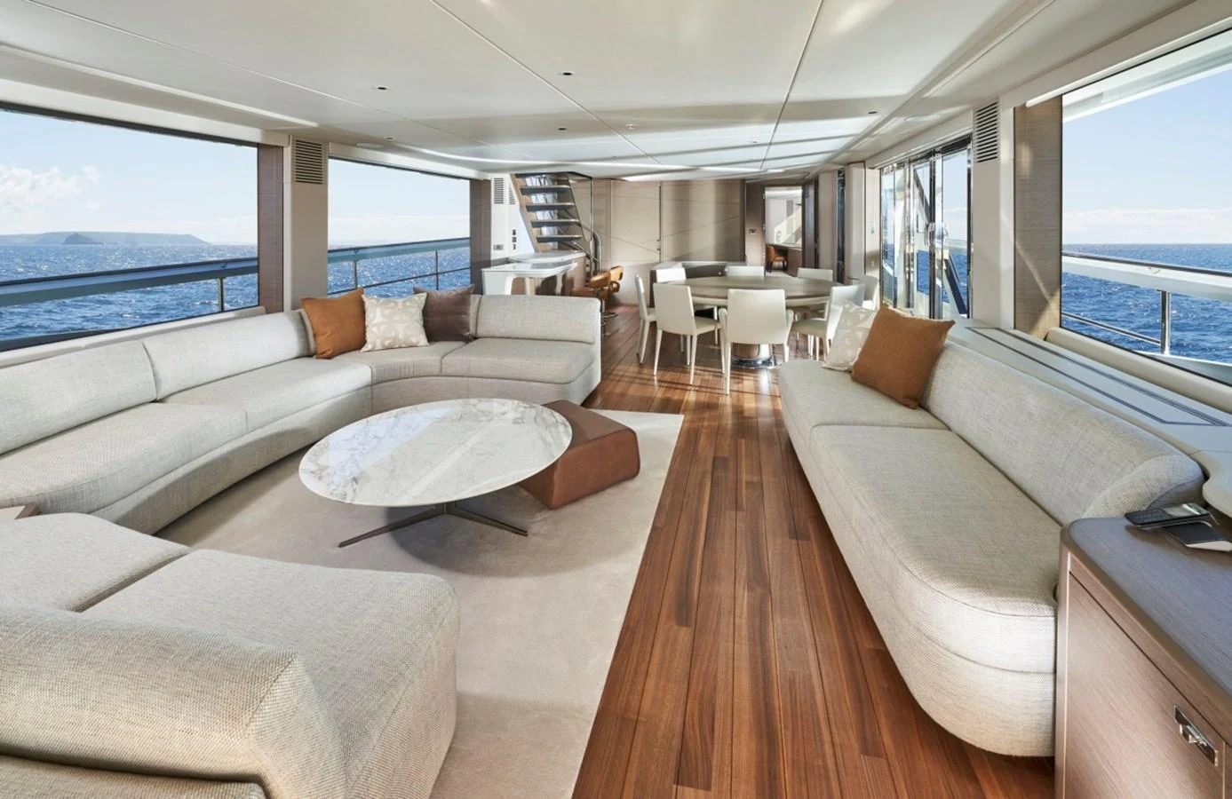 The spacious salon features elegant furnishings and panoramic ocean views. aboard OCEAN THREE Yacht for Sale