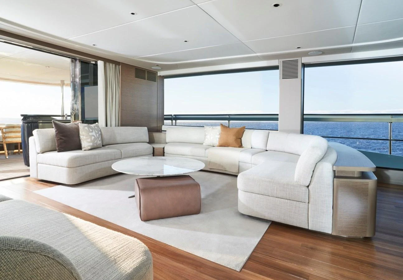 The salon features a spacious and elegant seating area with panoramic ocean views. aboard OCEAN THREE Yacht for Sale