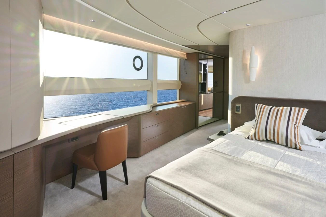A luxurious stateroom with a large window offering a stunning ocean view. aboard OCEAN THREE Yacht for Sale