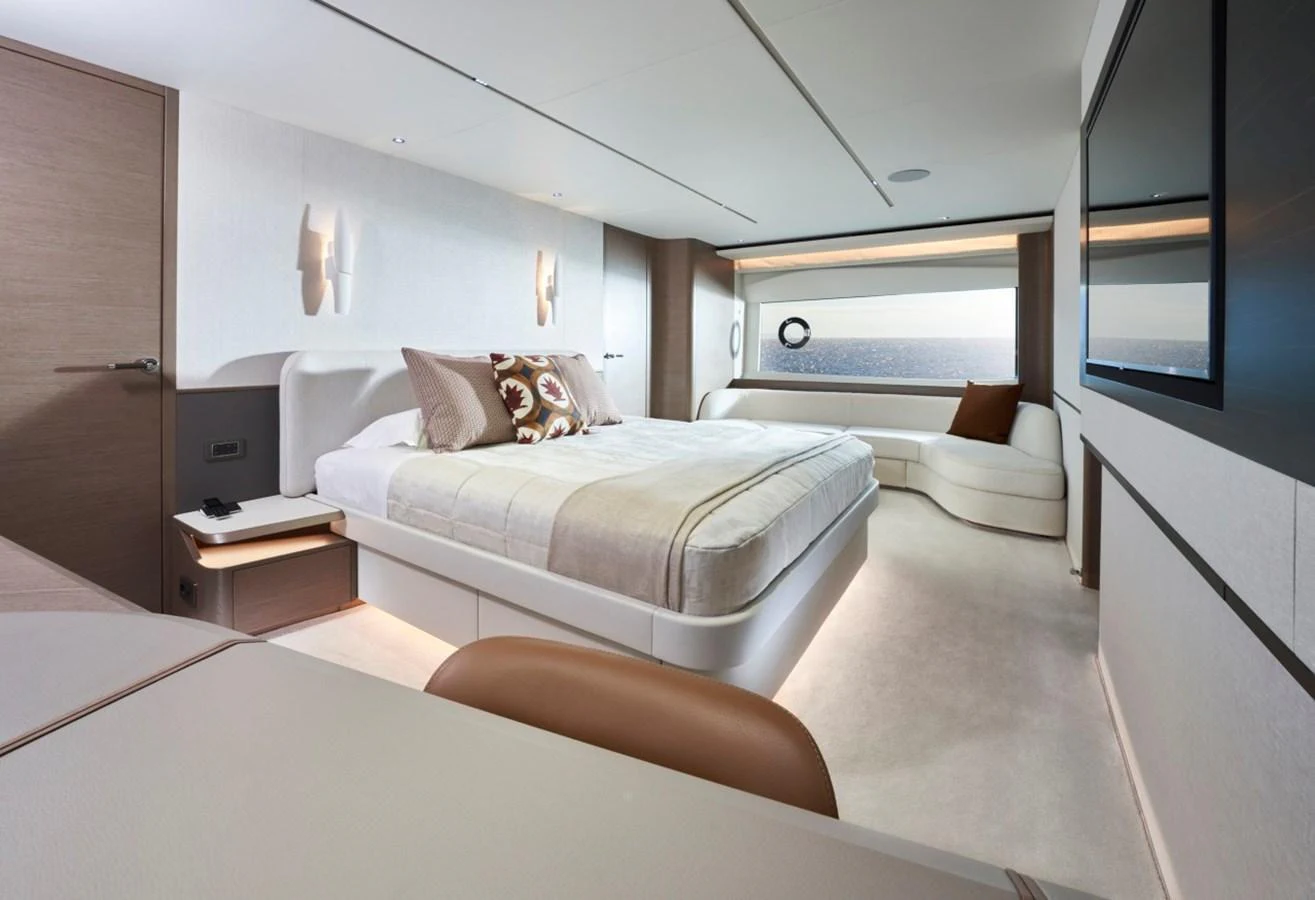 The master stateroom features a luxurious bed, modern decor, and ample natural light. aboard OCEAN THREE Yacht for Sale