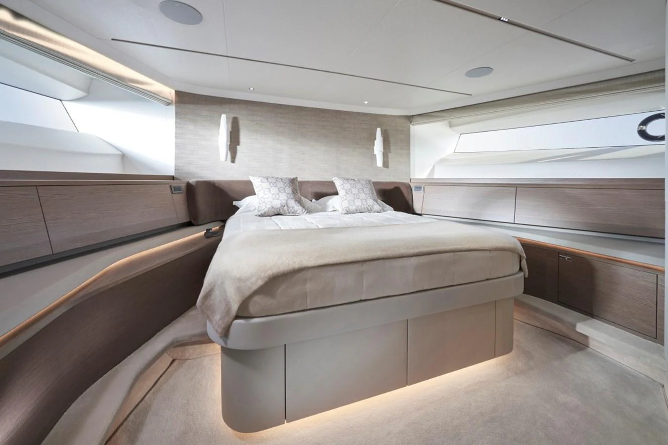 The master stateroom features a luxurious bed with ample natural light and modern design elements. aboard OCEAN THREE Yacht for Sale