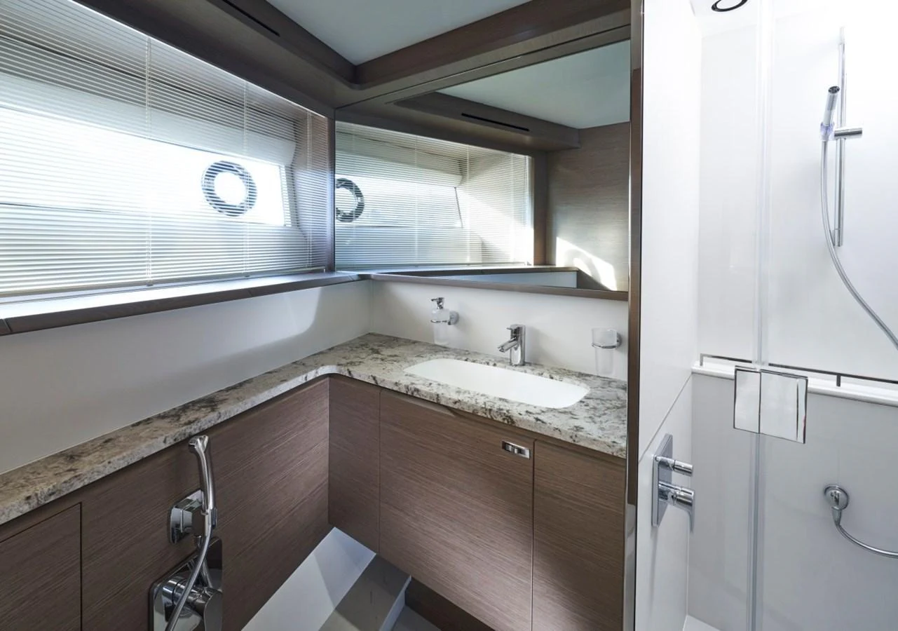 A sleek and modern yacht bathroom with a spacious shower and elegant fixtures. aboard OCEAN THREE Yacht for Sale
