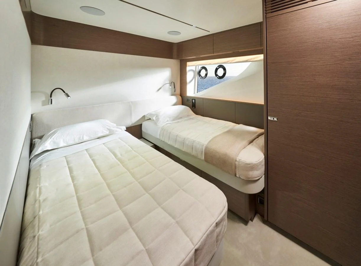 The guest stateroom features twin beds with a sleek, modern design and ample natural light. aboard OCEAN THREE Yacht for Sale