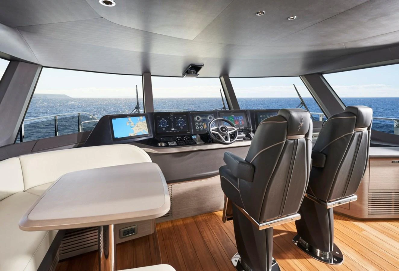 The helm station offers a commanding view with state-of-the-art navigation equipment and luxurious seating. aboard OCEAN THREE Yacht for Sale