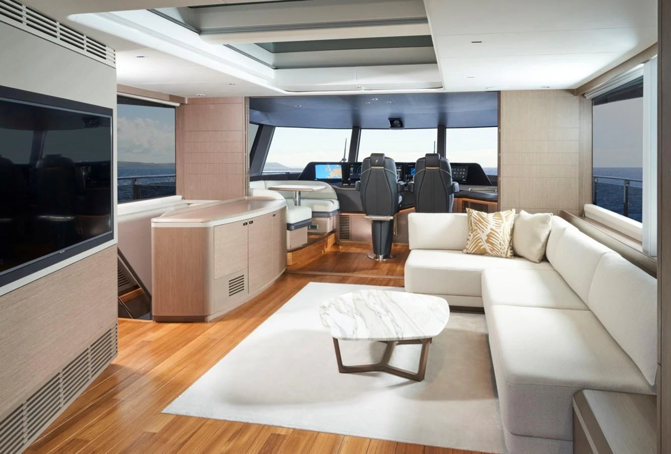 The yacht's salon features a spacious and modern design with ample seating and a large flat-screen TV. aboard OCEAN THREE Yacht for Sale