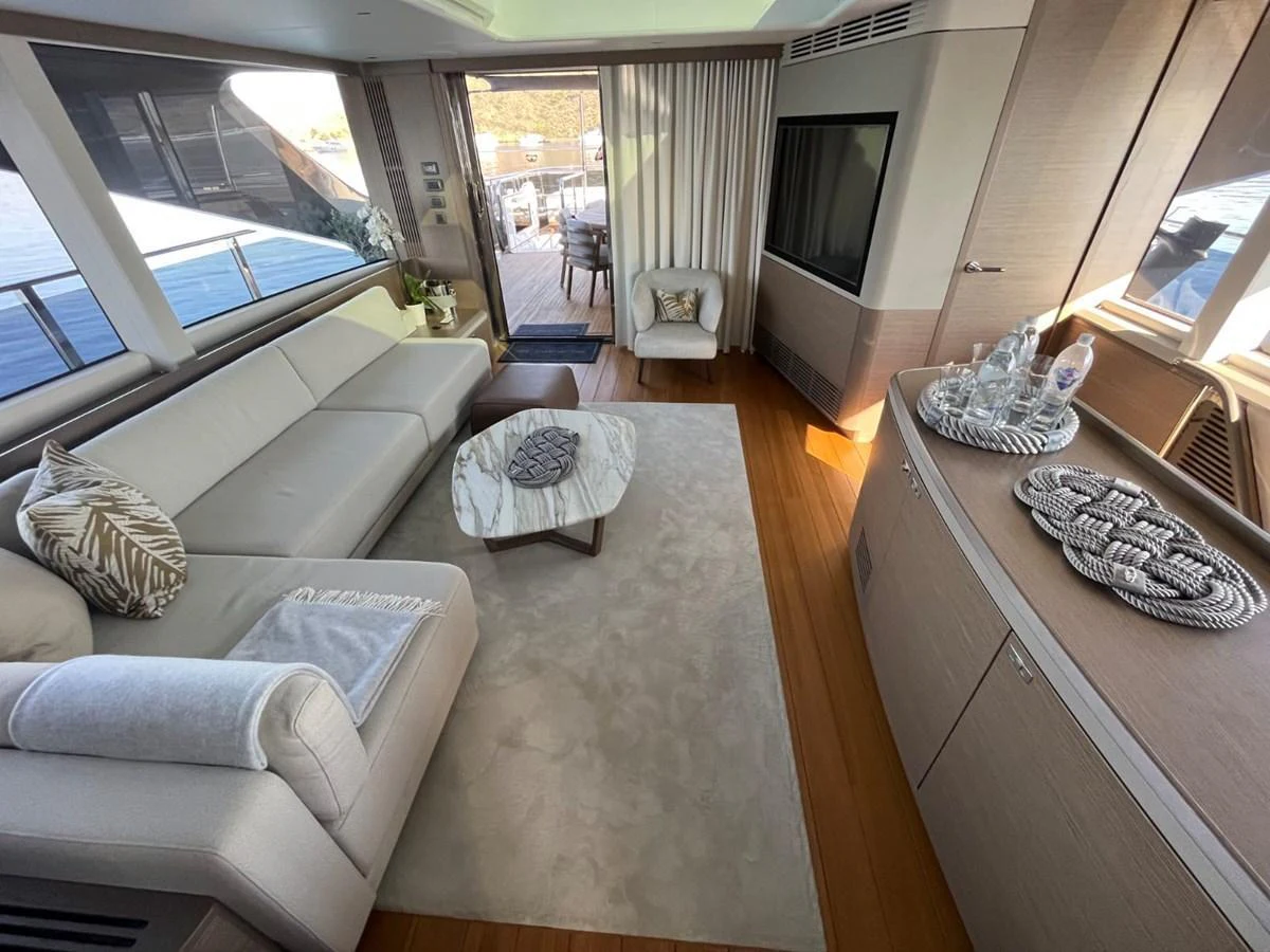 The salon features a luxurious seating area with a modern design and ample natural light. aboard OCEAN THREE Yacht for Sale