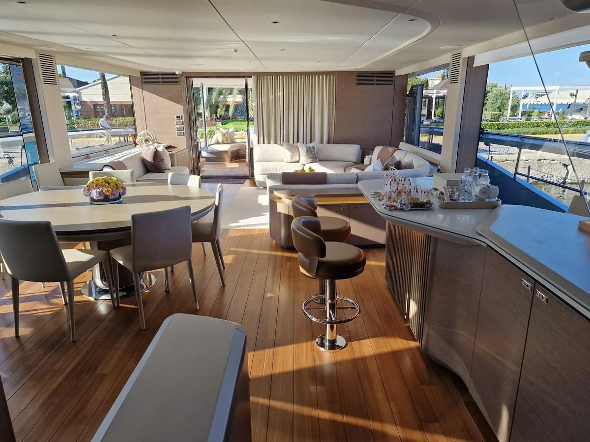 The salon features elegant furnishings and ample natural light, creating a welcoming and luxurious atmosphere. aboard OCEAN THREE Yacht for Sale