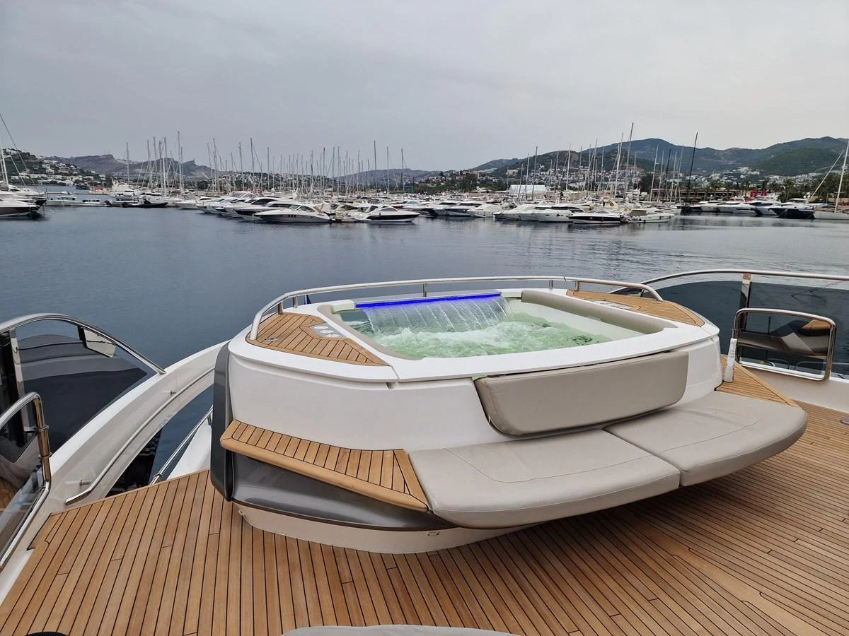 The yacht features a luxurious jacuzzi on the deck, offering a perfect spot for relaxation with a view of the marina. aboard OCEAN THREE Yacht for Sale