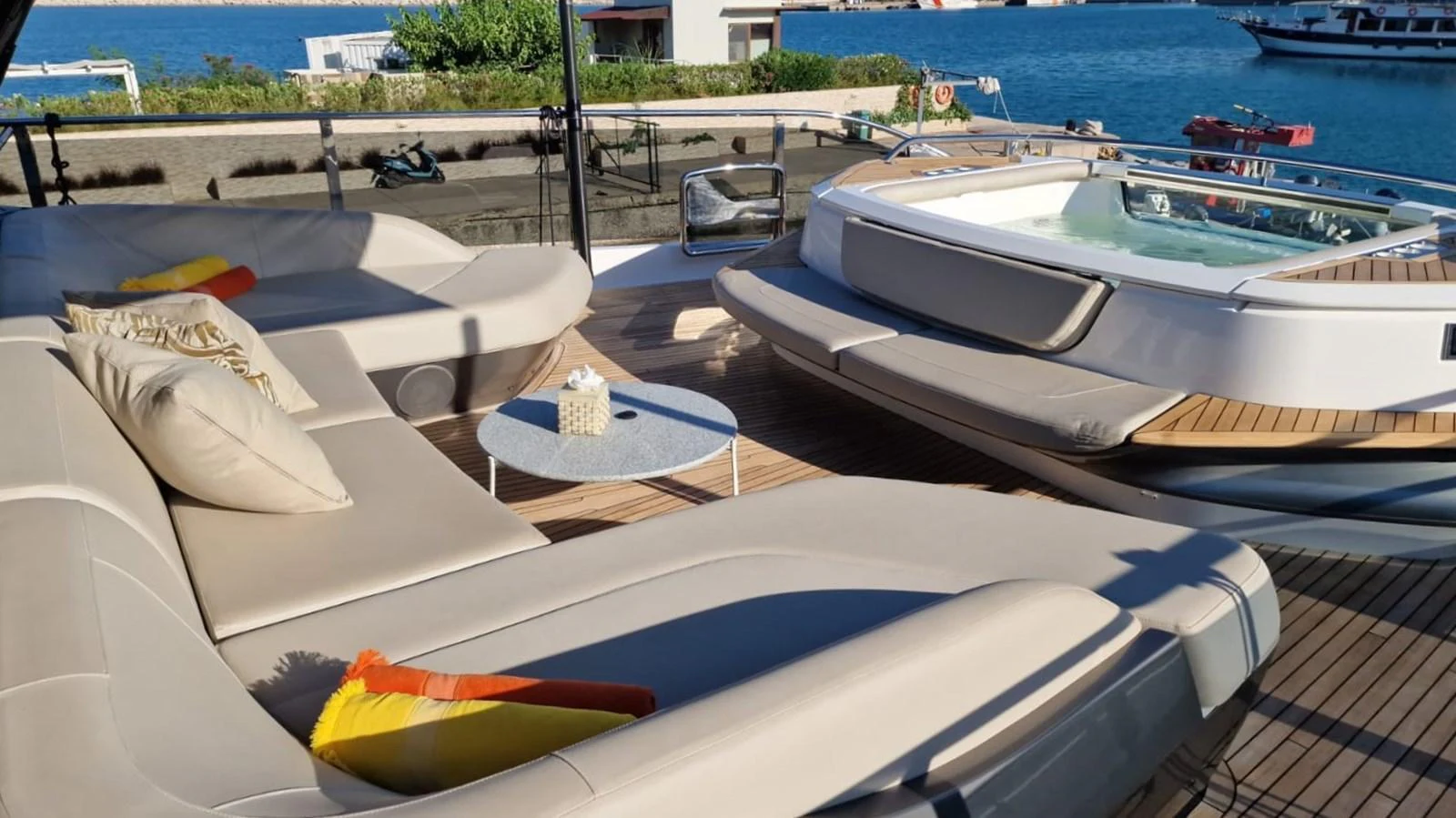 The sundeck features a luxurious lounging area with a jacuzzi, perfect for relaxation and enjoying the view. aboard OCEAN THREE Yacht for Sale