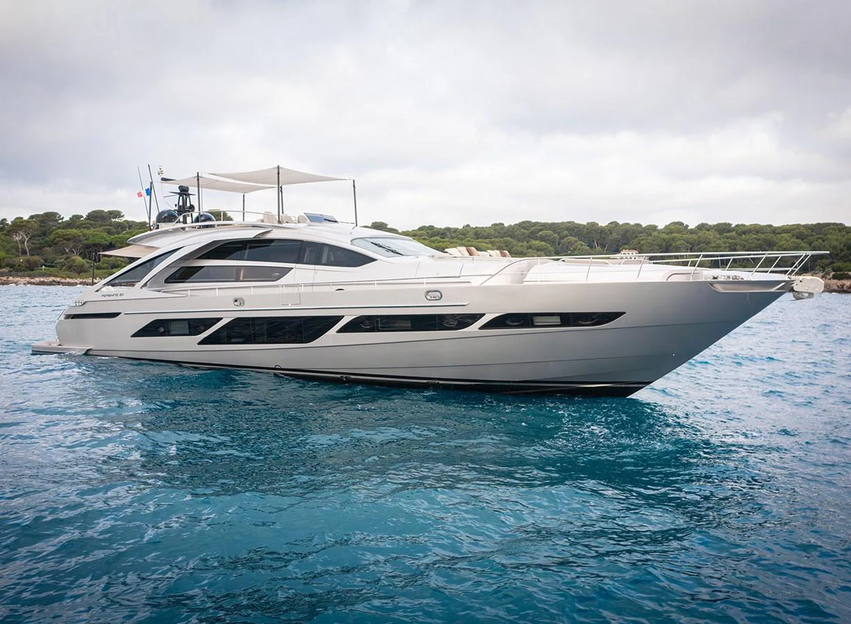 A sleek and modern yacht cruising on calm waters with a scenic backdrop. aboard MAGIC OF AYR Yacht for Sale