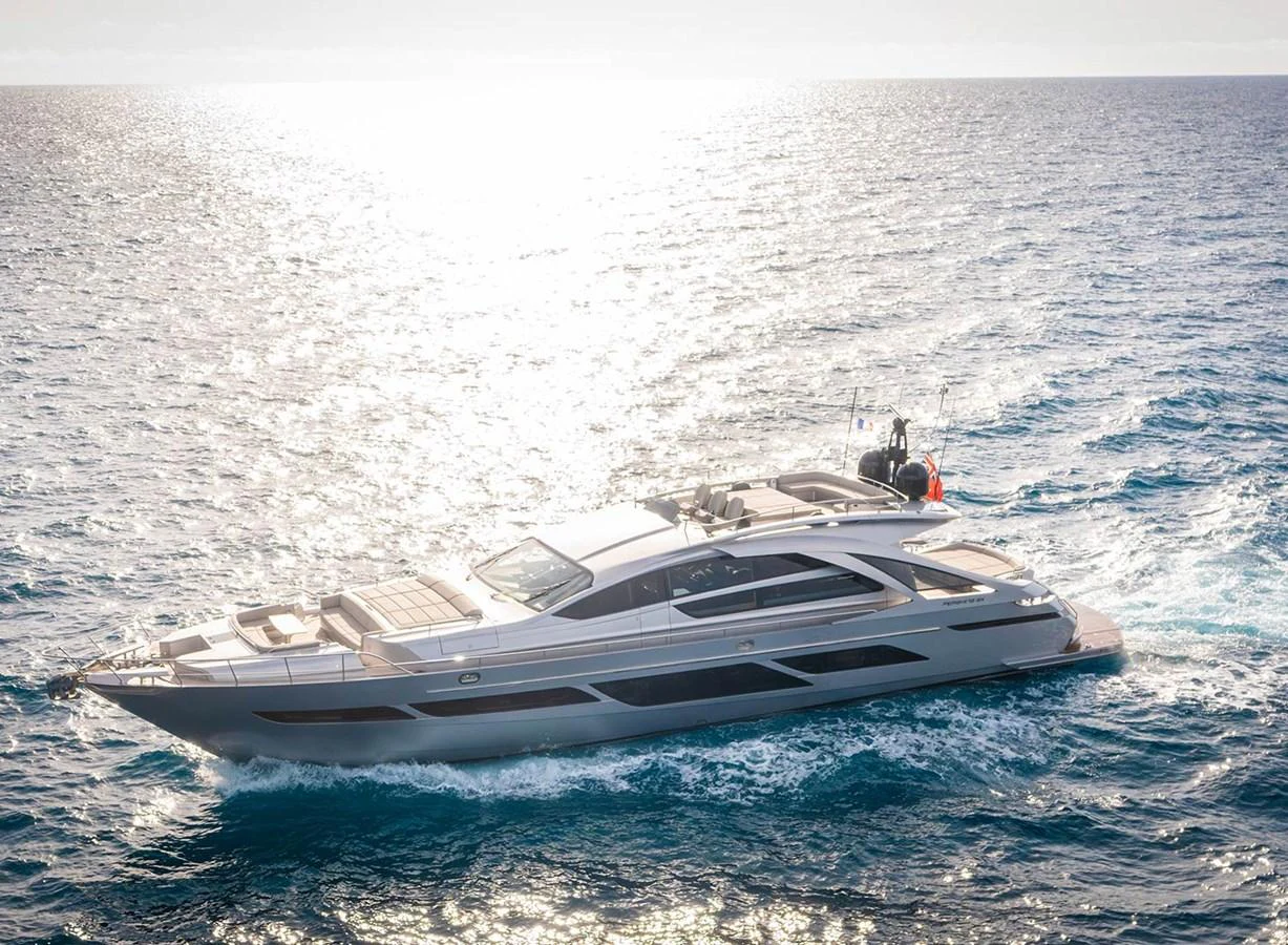 A sleek and modern yacht cruising on the open sea under the bright sun. aboard MAGIC OF AYR Yacht for Sale