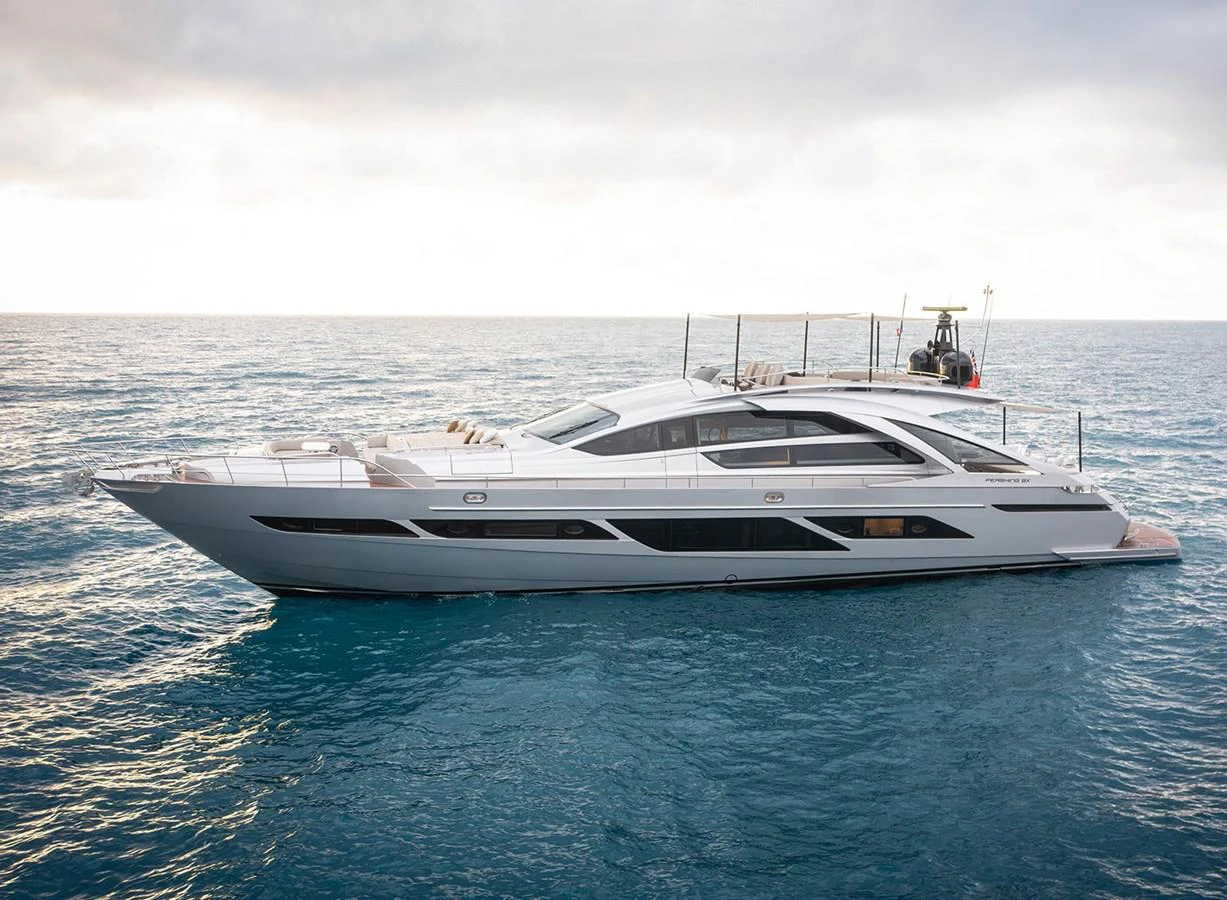 A sleek and modern yacht glides gracefully on the open sea under a cloudy sky. aboard MAGIC OF AYR Yacht for Sale
