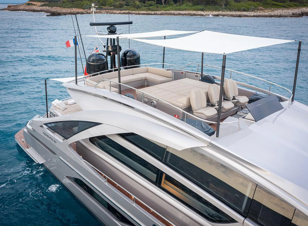 The yacht's sleek flybridge offers a luxurious outdoor lounging area with ample seating and shade. aboard MAGIC OF AYR Yacht for Sale