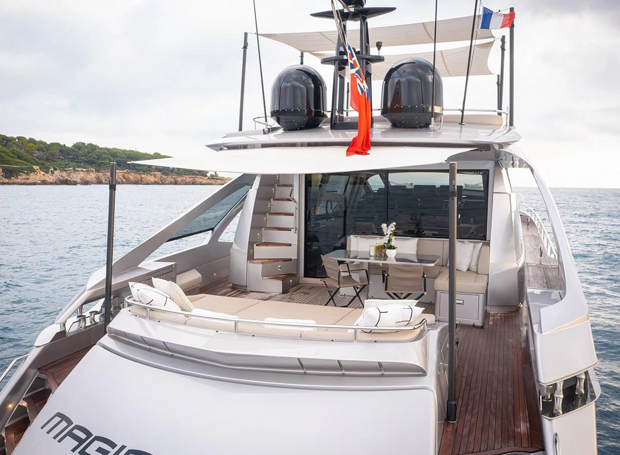 The yacht's aft deck features a spacious lounging area with elegant seating and a view of the serene waters. aboard MAGIC OF AYR Yacht for Sale