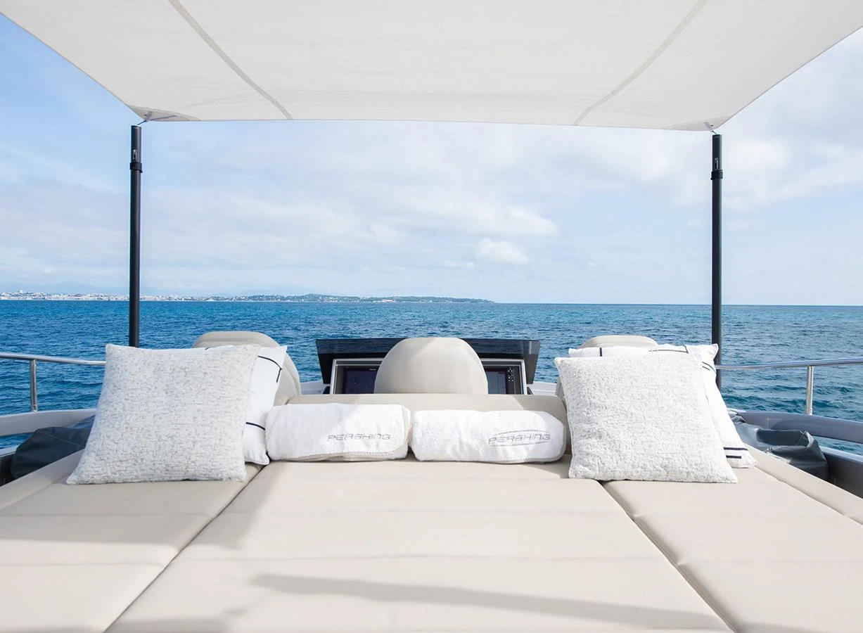 The sundeck offers a luxurious lounging area with plush cushions and a stunning sea view. aboard MAGIC OF AYR Yacht for Sale