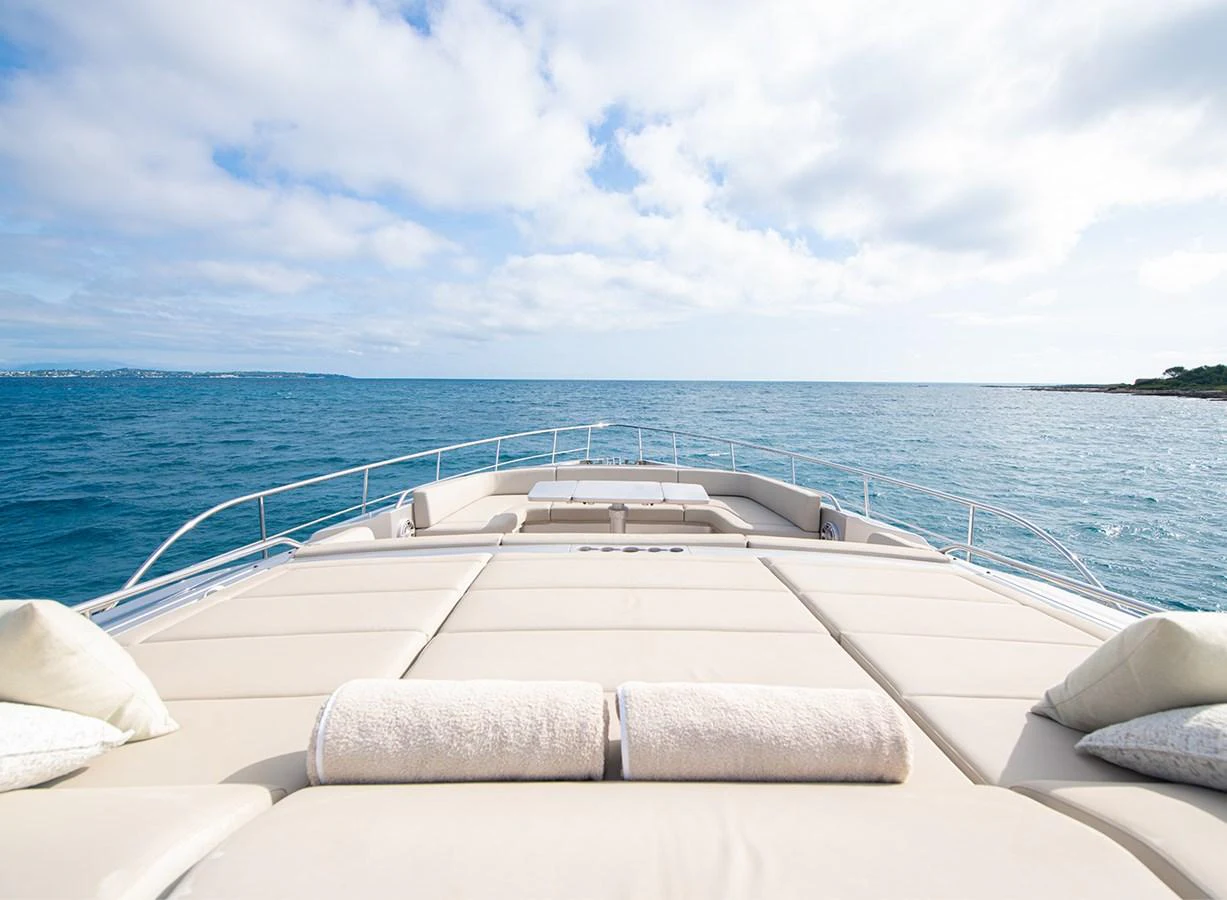 The yacht's spacious foredeck offers a luxurious sunbathing area with plush cushions and panoramic ocean views. aboard MAGIC OF AYR Yacht for Sale