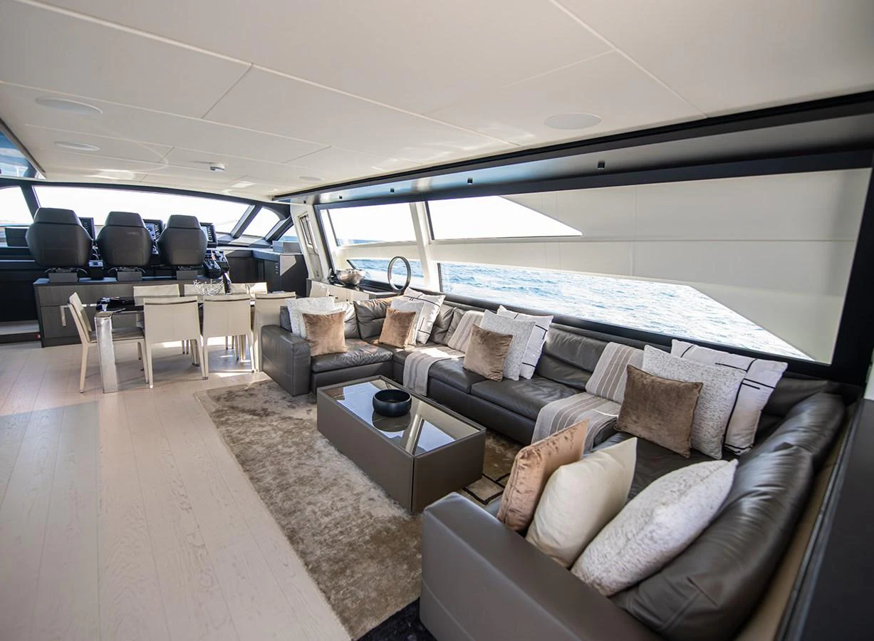 The spacious salon features luxurious seating and a dining area with panoramic ocean views. aboard MAGIC OF AYR Yacht for Sale