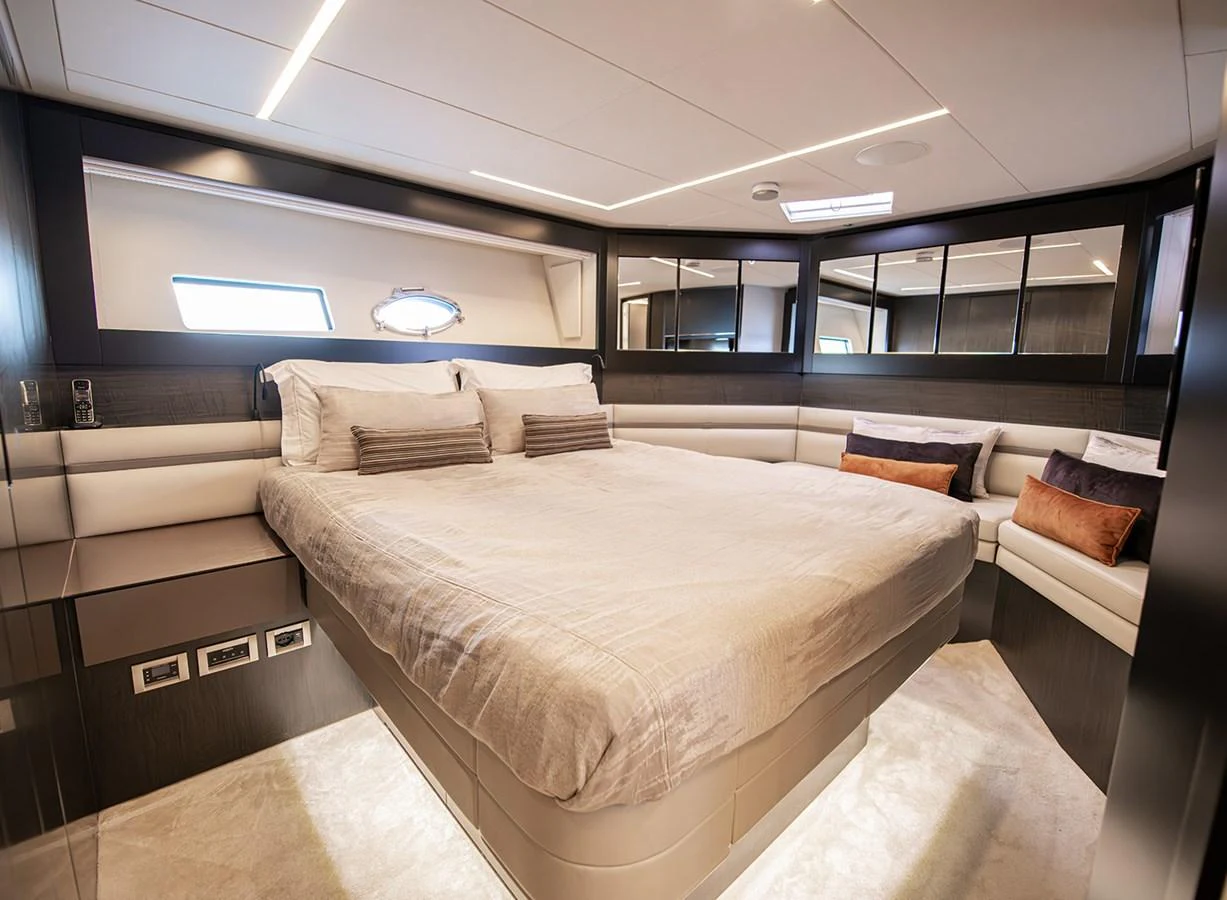 The stateroom features a spacious bed with luxurious bedding and ample natural light. aboard MAGIC OF AYR Yacht for Sale