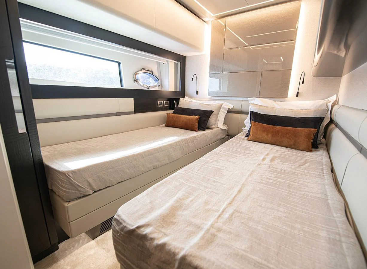 The guest stateroom features twin beds with luxurious bedding and modern lighting. aboard MAGIC OF AYR Yacht for Sale