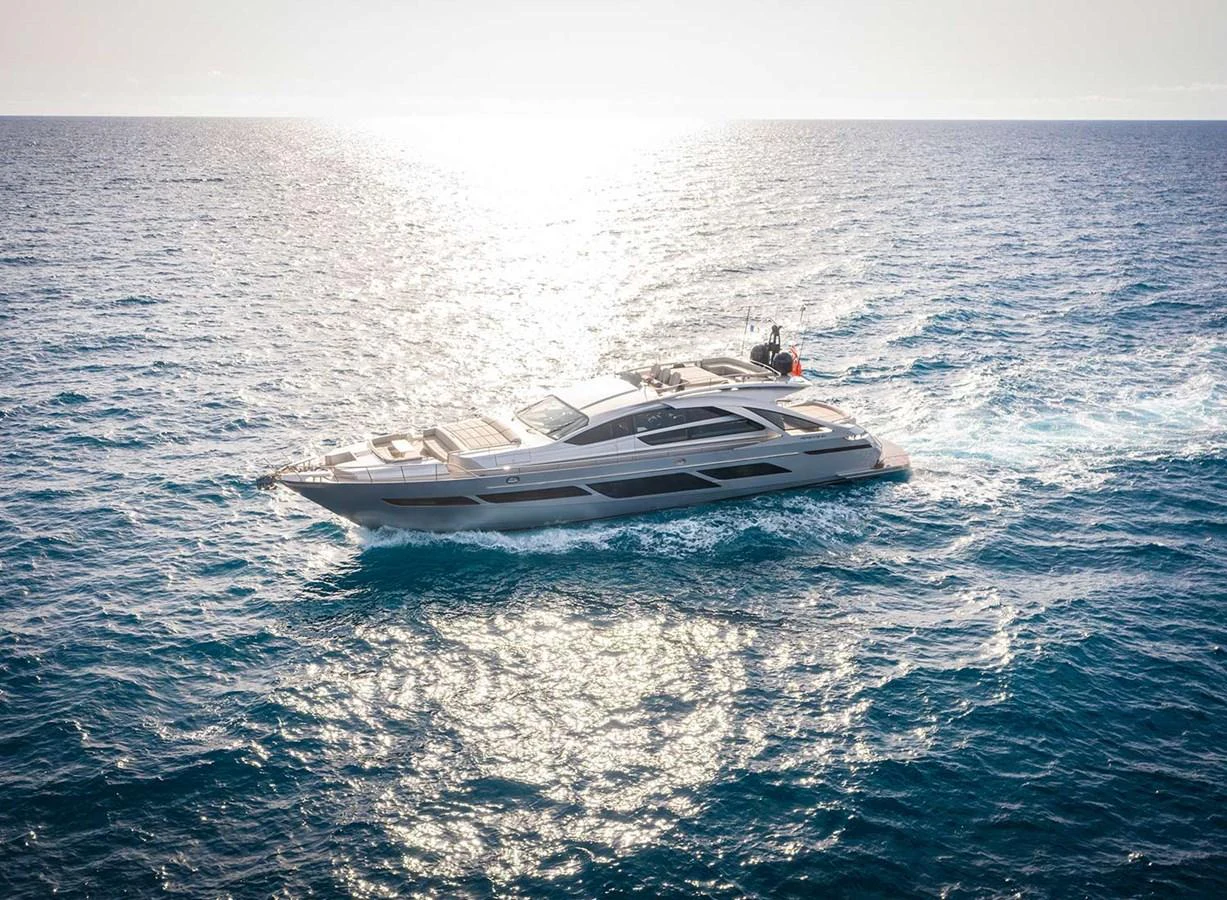 A sleek yacht glides through the open sea under a bright sun. aboard MAGIC OF AYR Yacht for Sale