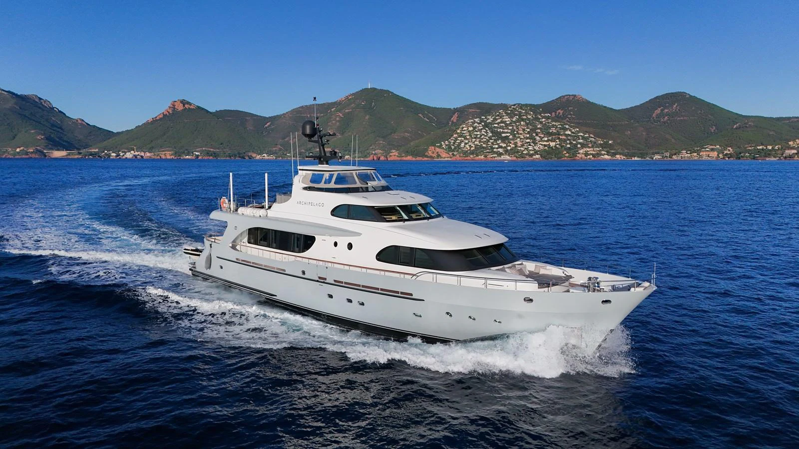 a white yacht on the water aboard ARCHIPELAGO Yacht for Sale