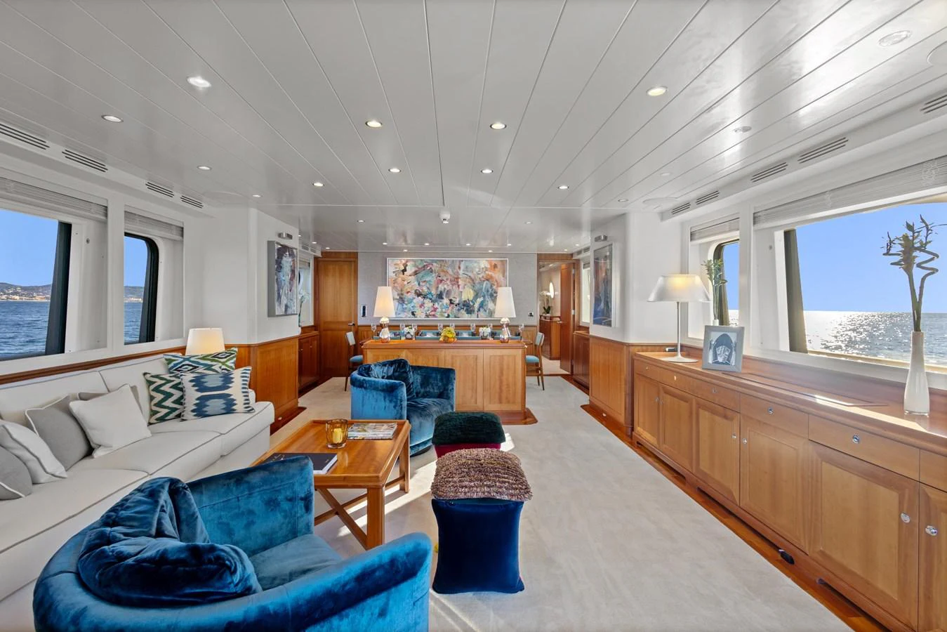 a living room with a large wood table and a large window aboard ARCHIPELAGO Yacht for Sale