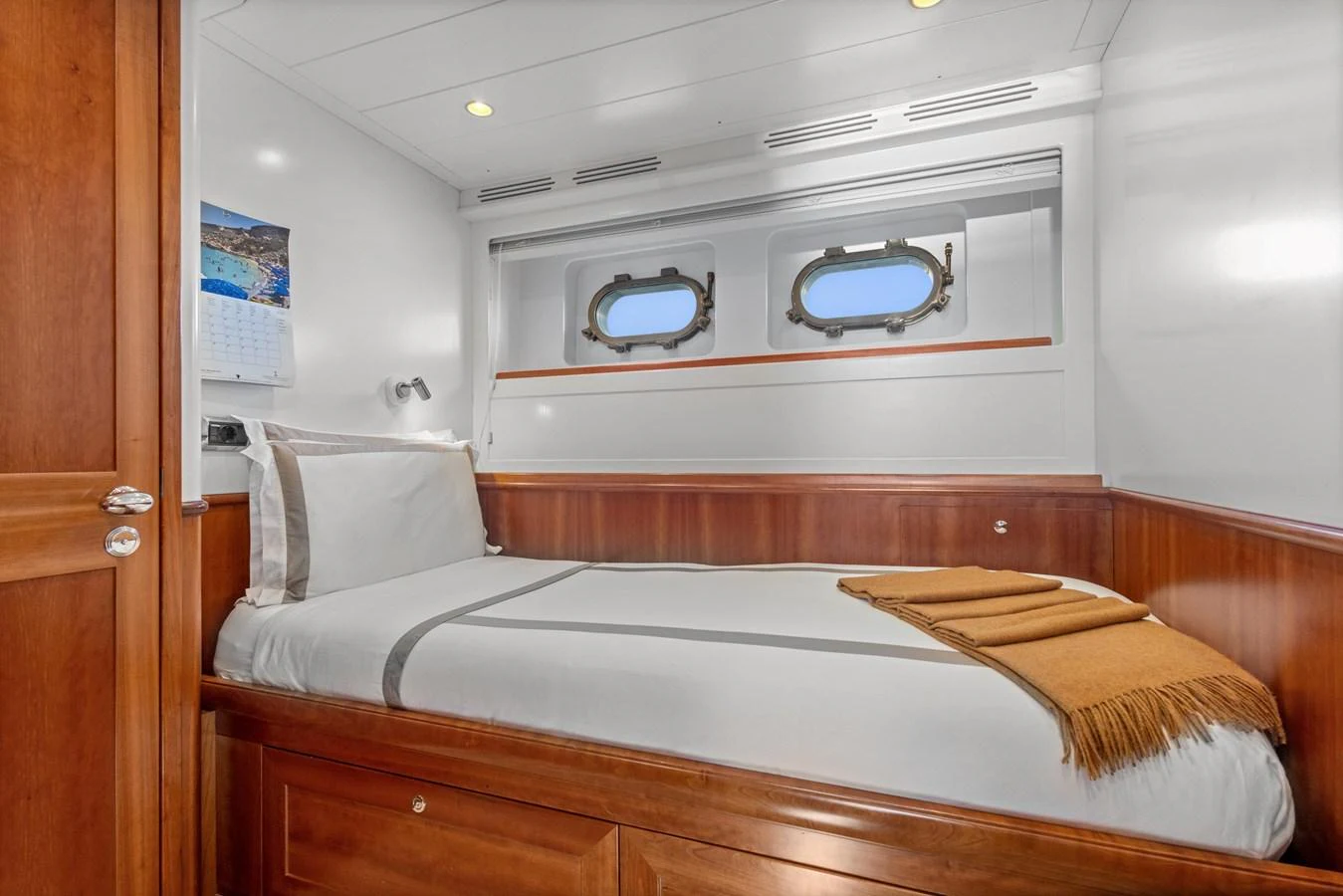 a bed with a television on the wall aboard ARCHIPELAGO Yacht for Sale