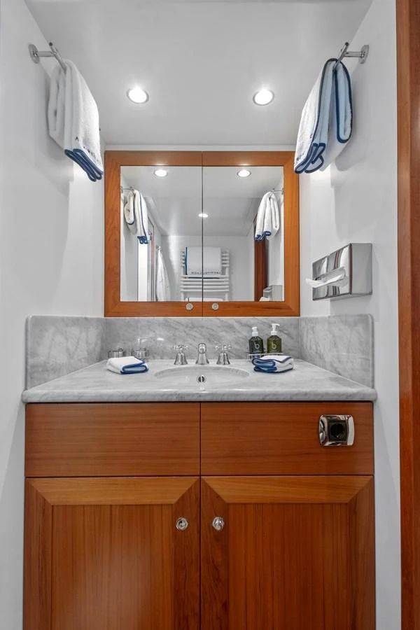 a bathroom with a sink and mirror aboard ARCHIPELAGO Yacht for Sale