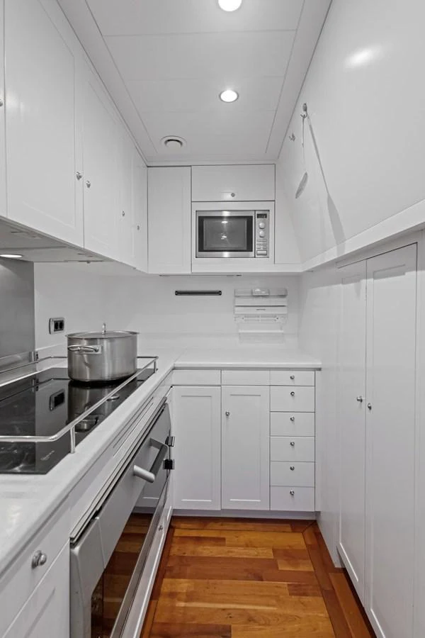 a kitchen with white cabinets aboard ARCHIPELAGO Yacht for Sale