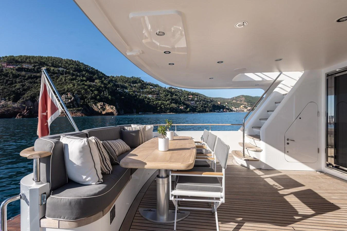 a deck with a table and chairs on it aboard ARCHIPELAGO Yacht for Sale
