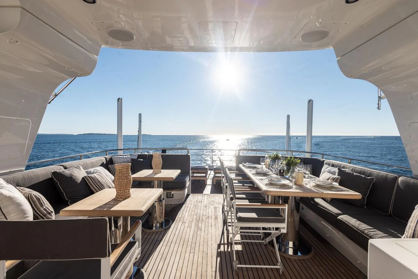 a deck with a table and chairs on it aboard ARCHIPELAGO Yacht for Sale