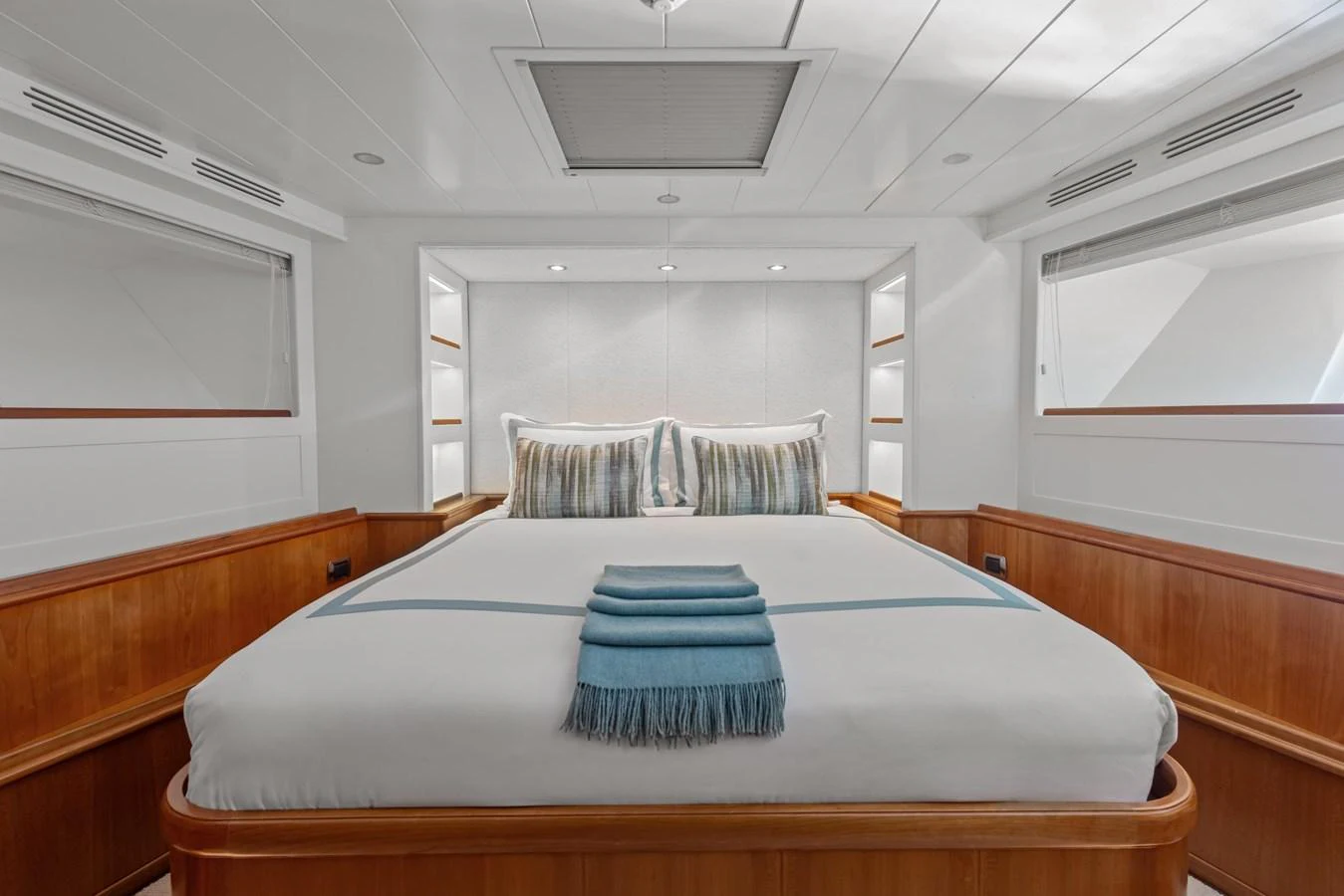 a bed with blue and white pillows aboard ARCHIPELAGO Yacht for Sale