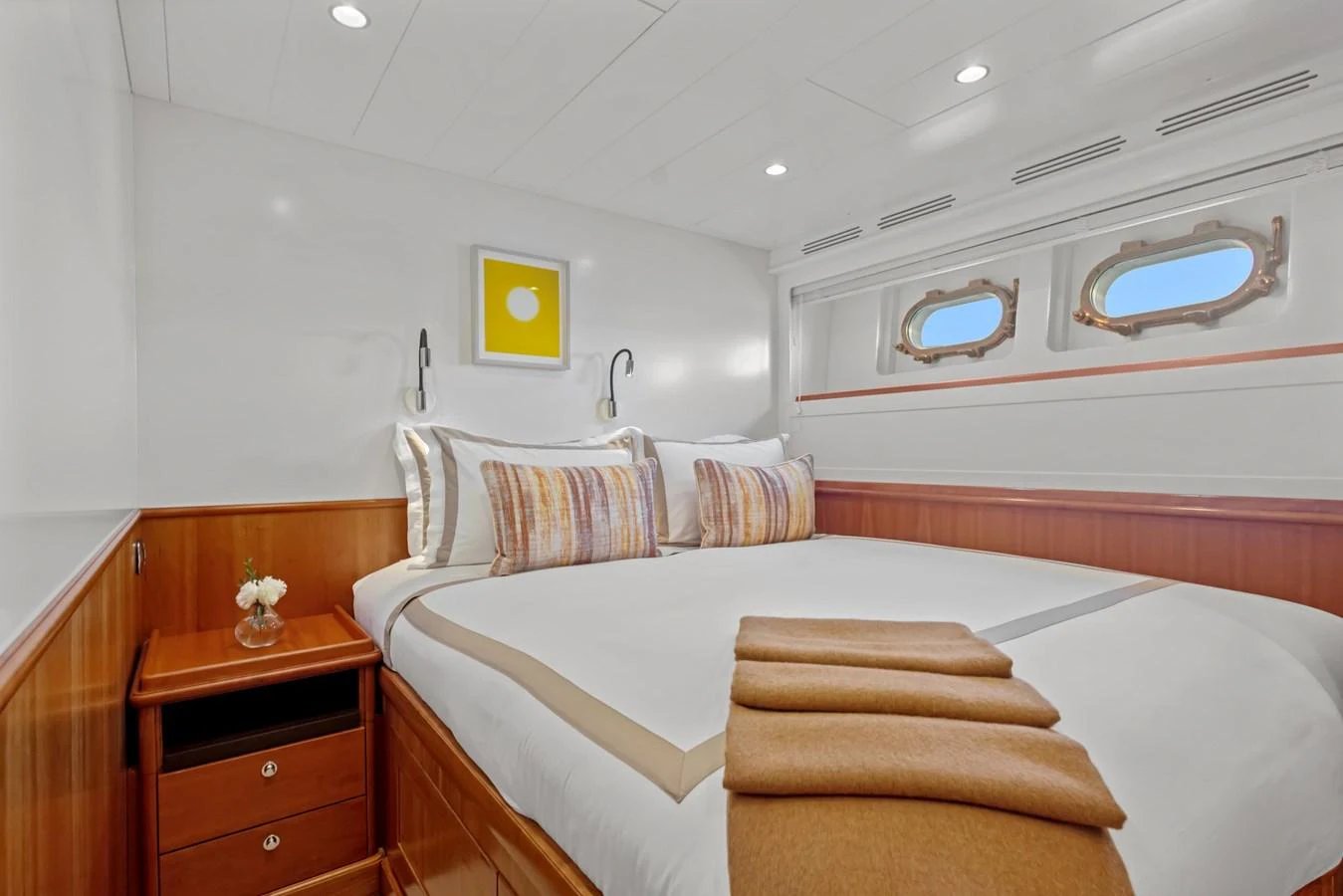 a room with a bed and a dresser aboard ARCHIPELAGO Yacht for Sale