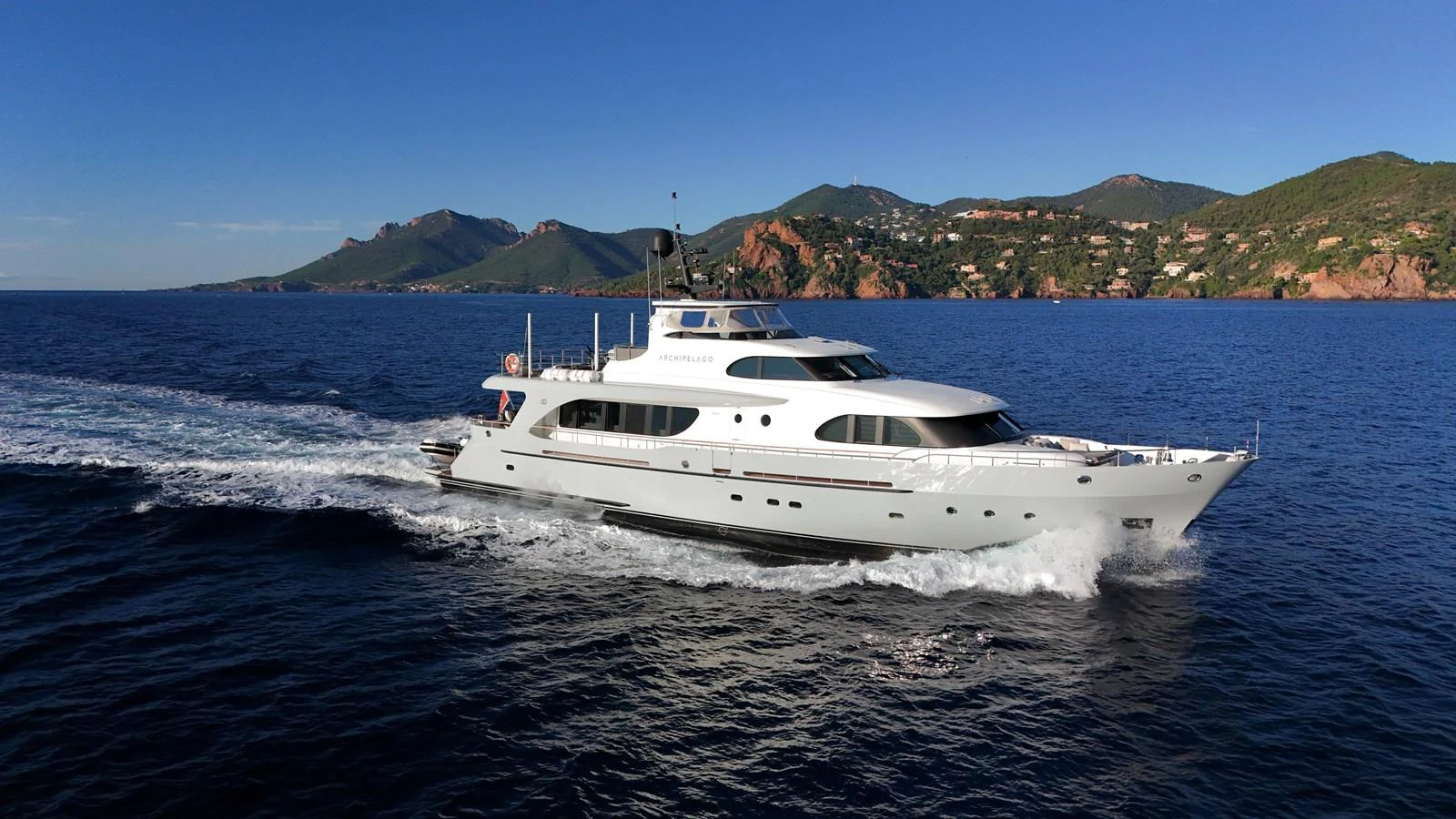 a white yacht on the water aboard ARCHIPELAGO Yacht for Sale