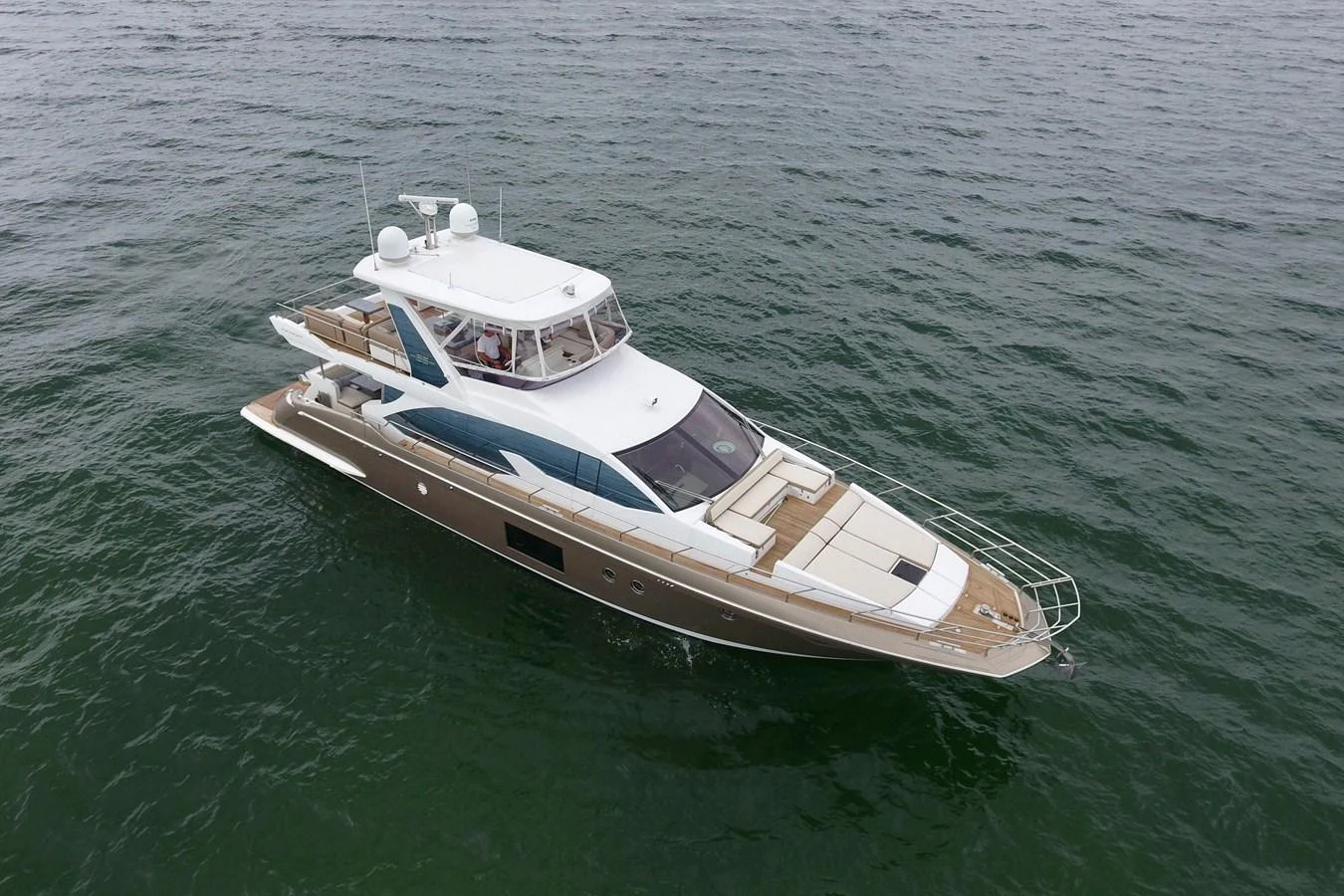 A sleek and modern yacht cruising on calm waters, showcasing its elegant design and spacious deck areas. aboard KIKI Yacht for Sale