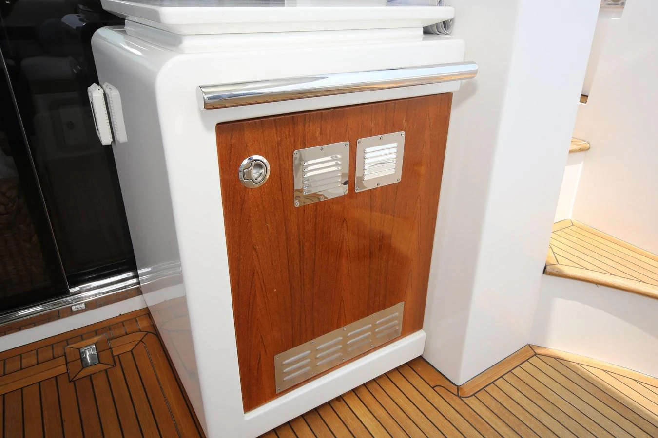 A close-up of a wooden and stainless steel cabinet on the yacht's deck. aboard KIKI Yacht for Sale