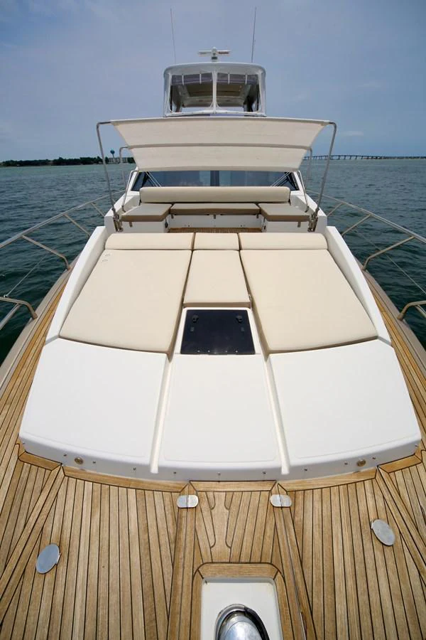 The yacht's foredeck features luxurious sun pads and a sleek teak deck, perfect for relaxation. aboard KIKI Yacht for Sale