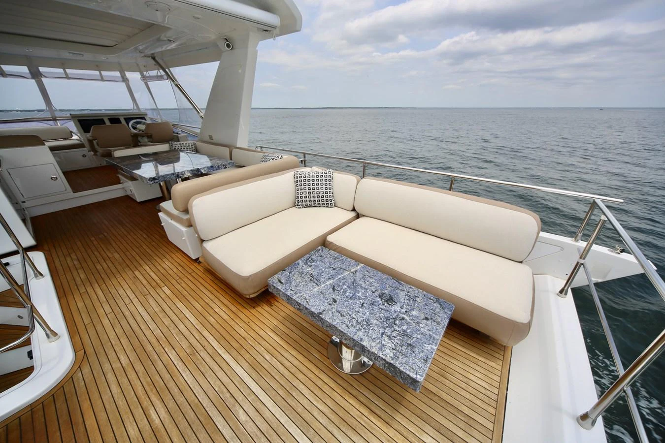 The aft deck offers a luxurious seating area with a stunning ocean view. aboard KIKI Yacht for Sale