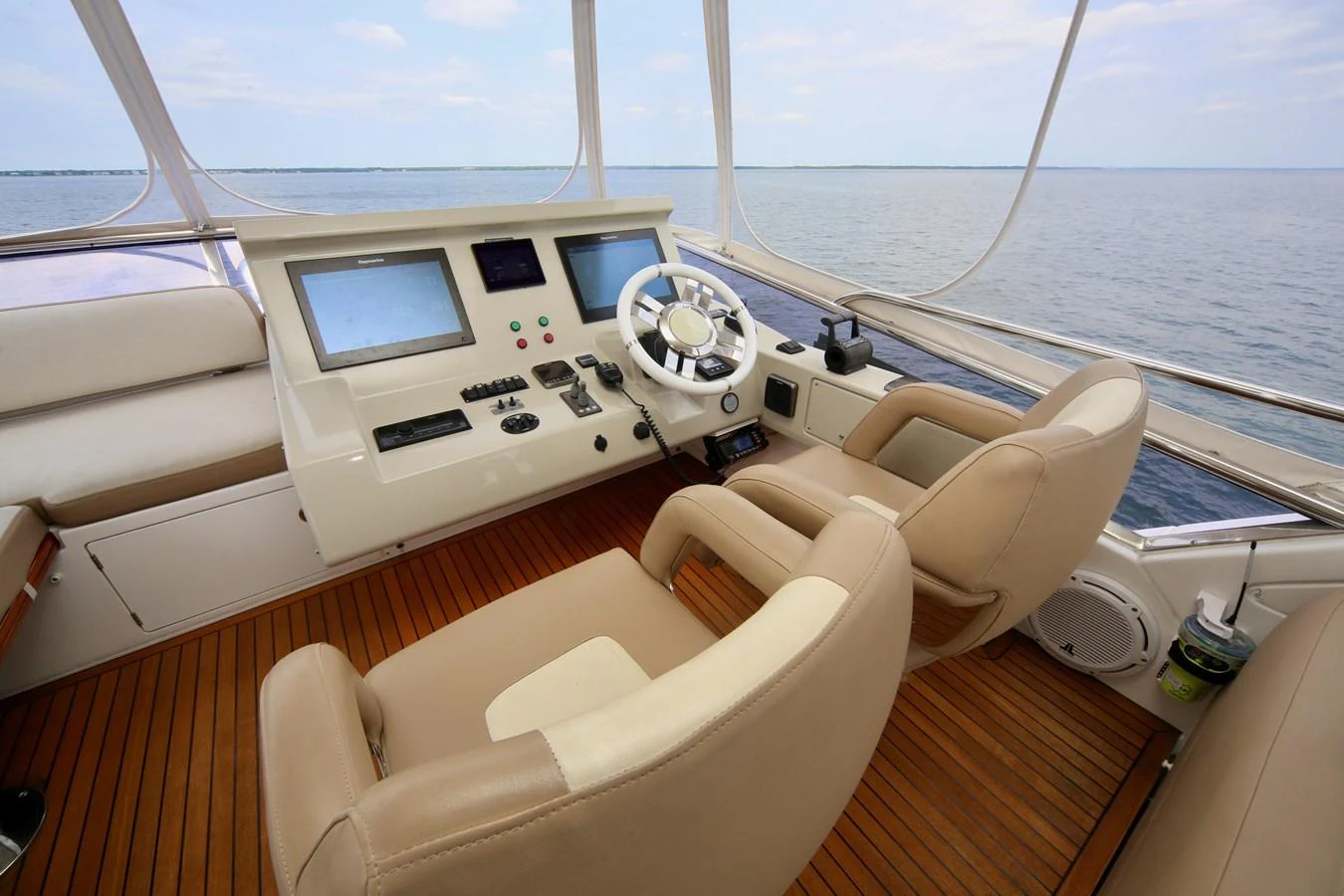 The helm station offers a commanding view with comfortable seating and advanced navigation equipment. aboard KIKI Yacht for Sale