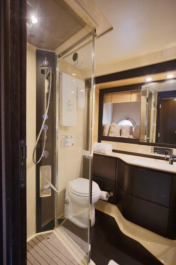 The yacht's bathroom features a modern shower, sleek vanity, and elegant fixtures. aboard KIKI Yacht for Sale