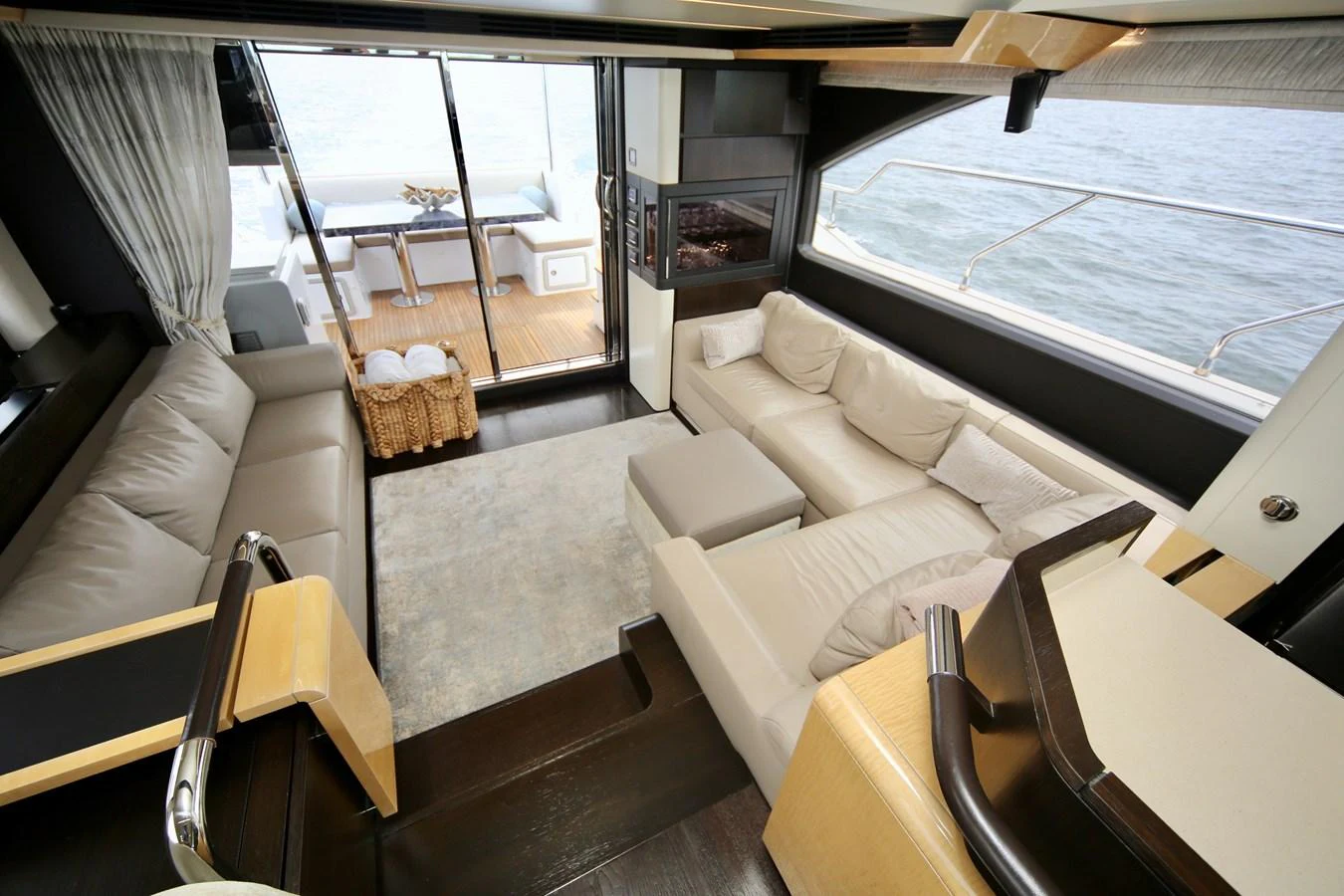 The salon offers a spacious and comfortable seating area with a view of the aft deck and the sea beyond. aboard KIKI Yacht for Sale