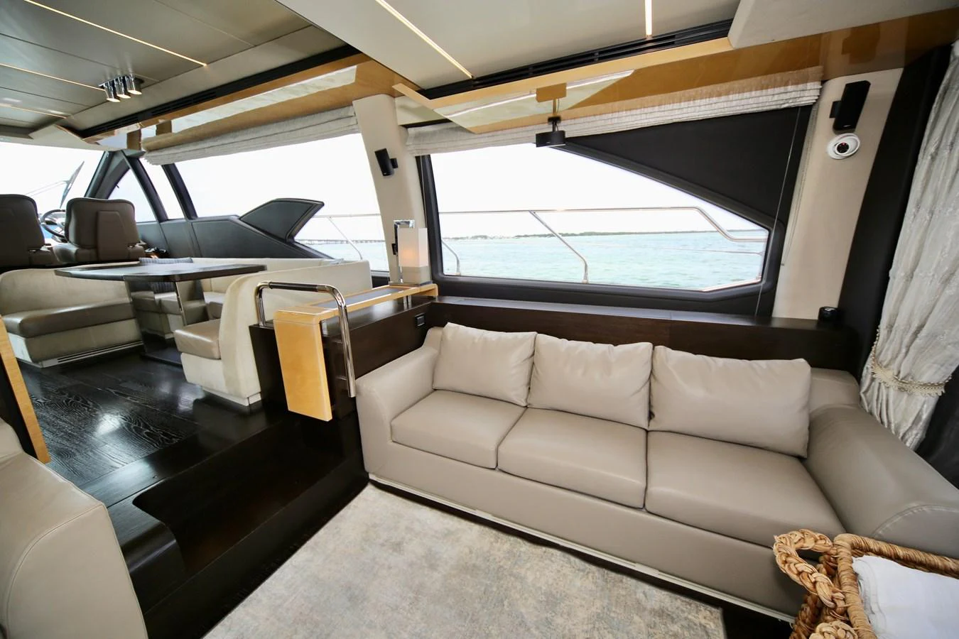 The salon features a luxurious seating area with large windows offering stunning ocean views. aboard KIKI Yacht for Sale