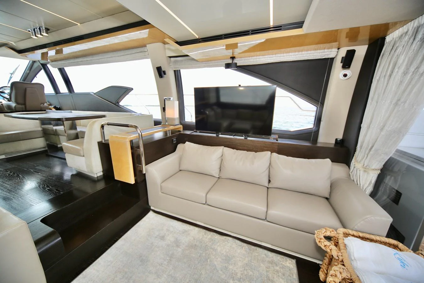 The salon features a comfortable seating area with a modern design and large windows offering stunning views. aboard KIKI Yacht for Sale
