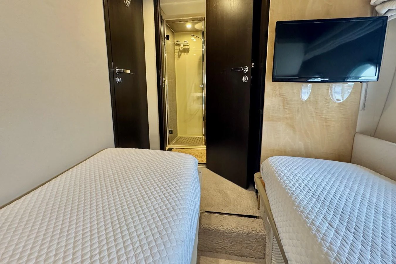 The guest cabin features twin beds and a private ensuite bathroom, offering comfort and privacy. aboard KIKI Yacht for Sale