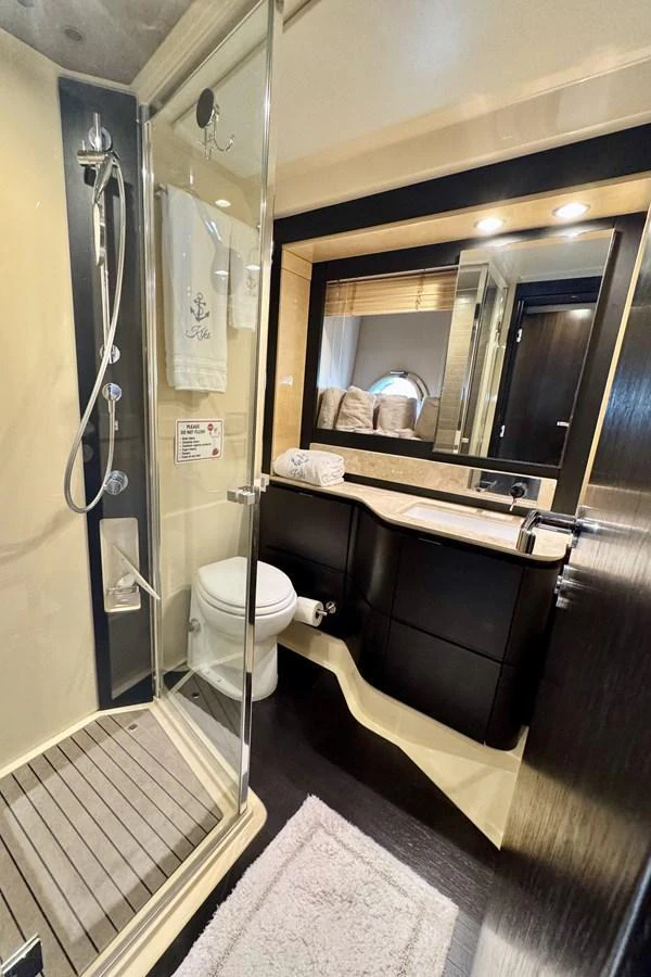 The yacht's bathroom features a sleek design with modern fixtures and a spacious shower. aboard KIKI Yacht for Sale