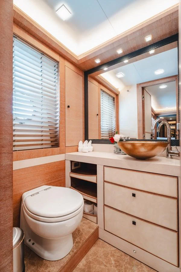 a bathroom with a toilet and a sink aboard MOANA Yacht for Sale