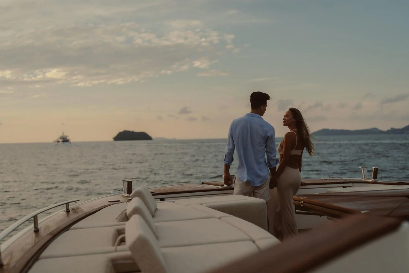 a man and woman sitting on a boat in the water aboard MOANA Yacht for Sale